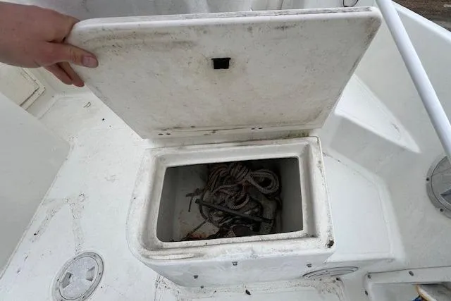 Slide: The Image of Open storage compartment on 2004 Hydra-Sports Lightning 212 WA boat with rope inside. - 14