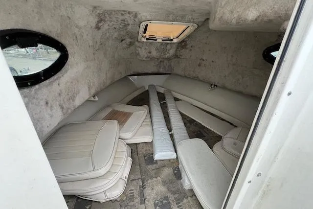 Slide: The Image of 2004 Hydra-Sports Lightning 212 WA cabin interior with cushions and portholes. - 16