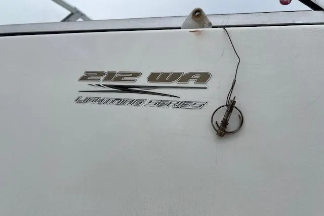 Slide: The Image of 2004 Hydra-Sports Lightning 212 WA boat emblem with visible crack and latch. - 17