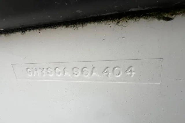 Slide: The Image of 2004 Hydra-Sports Lightning 212 WA hull identification number embossed on white surface. - 18