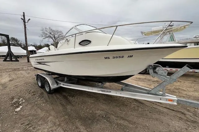 Slide: The Image of 2004 Hydra-Sports Lightning 212 WA boat on trailer, parked outdoors. - 2