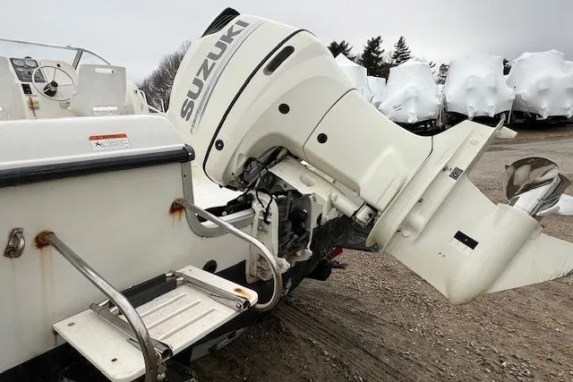 Slide: The Image of 2004 Hydra-Sports Lightning 212 WA with Suzuki outboard motor, parked on gravel. - 3