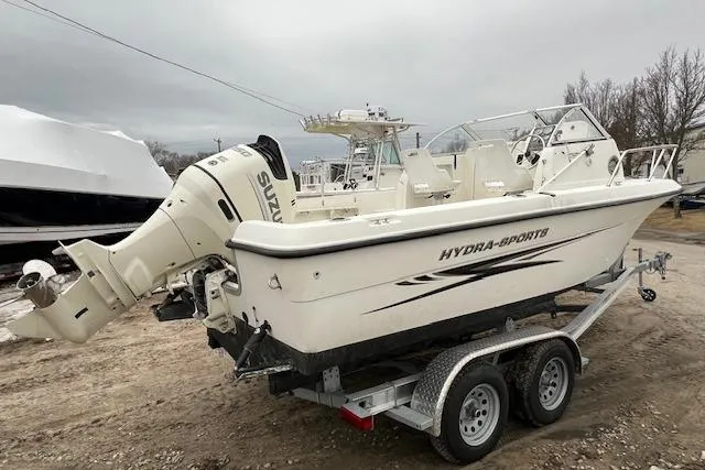 Slide: The Image of 2004 Hydra-Sports Lightning 212 WA boat on trailer, featuring Suzuki outboard motor. - 5