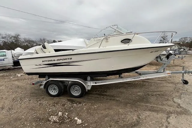 Slide: The Image of 2004 Hydra-Sports Lightning 212 WA boat on trailer, parked outdoors. - 6