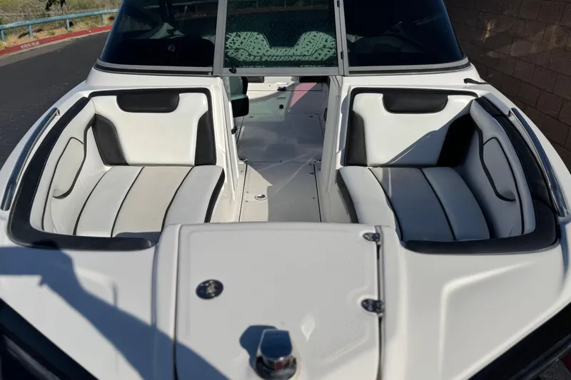 Slide: The Image of 2018 Yamaha Boats AR210 interior with white and black seating, showcasing bow area design. - 10