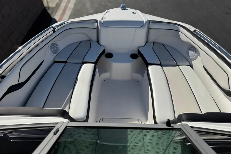 Slide: The Image of 2018 Yamaha Boats AR210 interior with white seating and cup holders. - 13