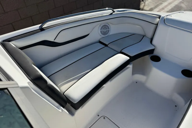 Slide: The Image of 2018 Yamaha Boats AR210 interior seating with sleek design and built-in speaker. - 14