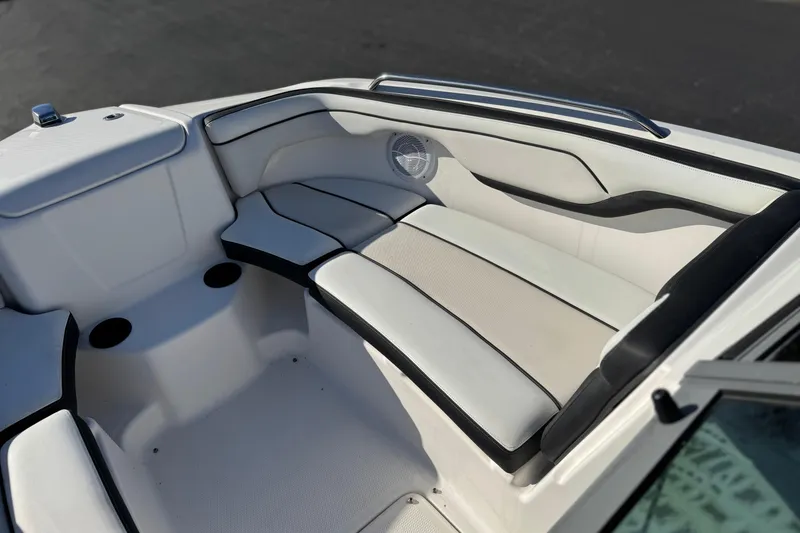 Slide: The Image of 2018 Yamaha AR210 boat interior with white cushioned seating and speaker. - 15