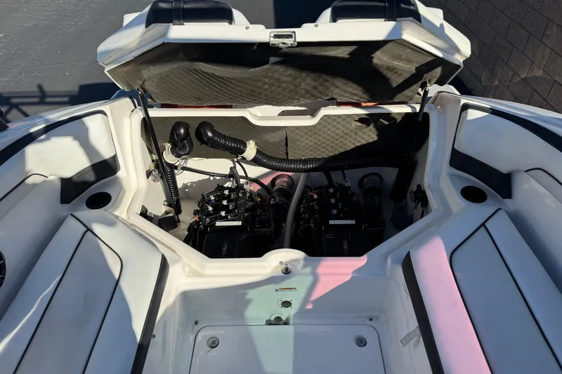 Slide: The Image of Open engine compartment of 2018 Yamaha Boats AR210, showcasing dual engines and interior layout. - 19