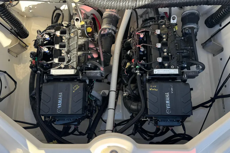 Slide: The Image of 2018 Yamaha AR210 boat engine compartment with dual engines and wiring. - 20