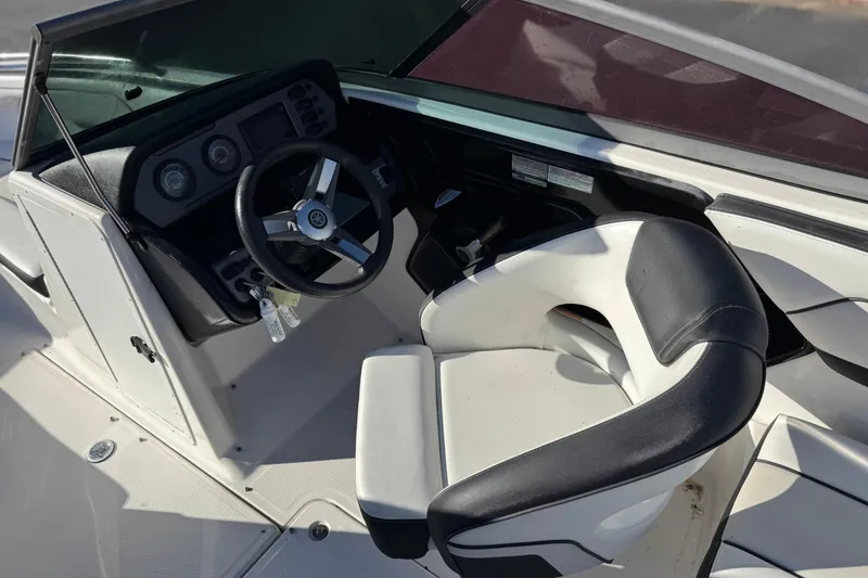 Slide: The Image of 2018 Yamaha Boats AR210 cockpit with steering wheel and seating. - 22