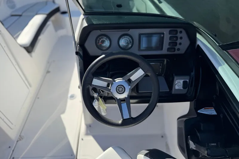 Slide: The Image of 2018 Yamaha Boats AR210 dashboard with steering wheel and control panel. - 23
