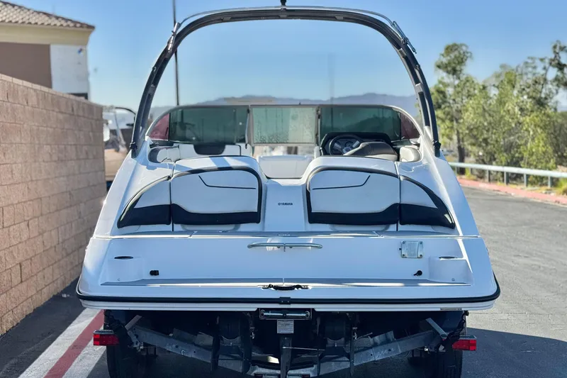 Slide: The Image of 2018 Yamaha Boats AR210 on trailer, rear view, parked outdoors. - 4
