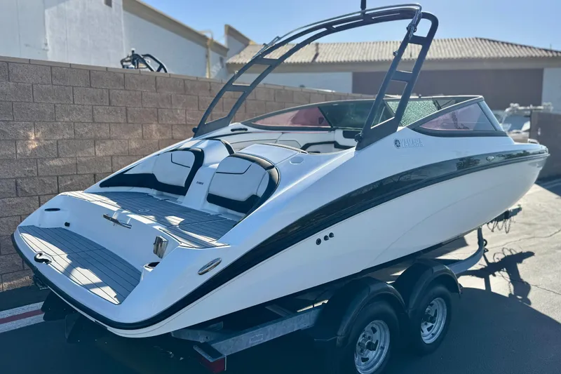 Slide: The Image of 2018 Yamaha Boats AR210 on trailer, sleek design, parked outdoors. - 5