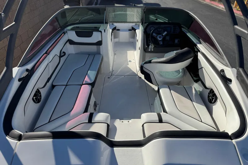 Slide: The Image of 2018 Yamaha Boats AR210 interior with seating and steering wheel, showcasing modern design. - 9