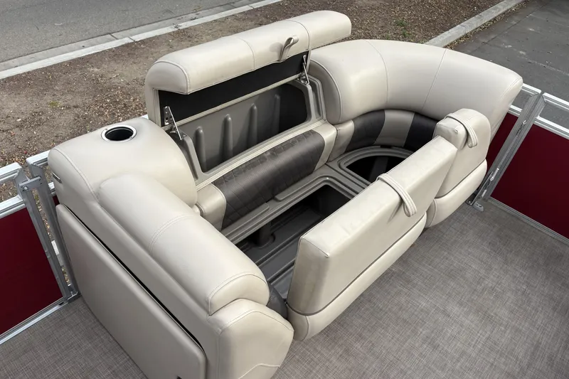 Slide: The Image of 2024 Sun Tracker Party Barge 20 DLX seating with storage compartments and cup holder. - 21