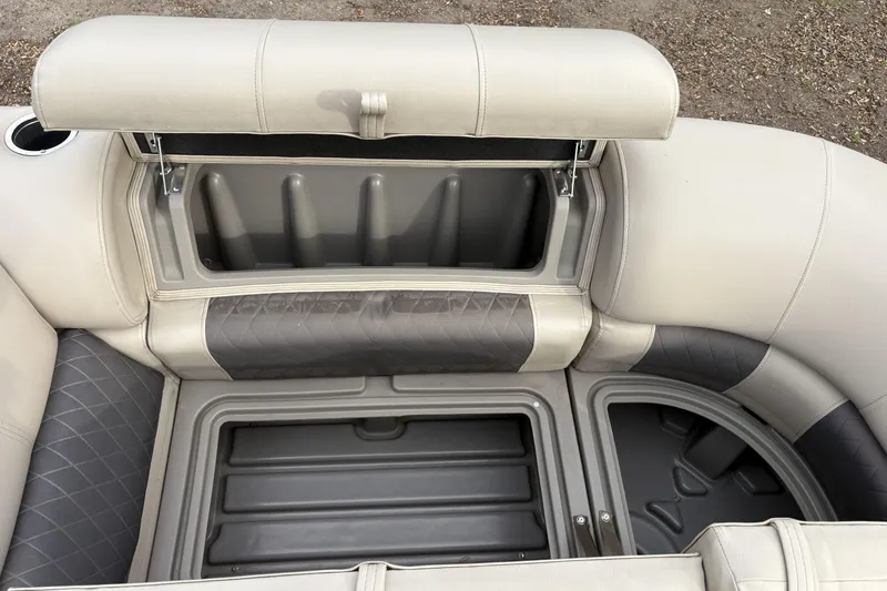 Slide: The Image of 2024 Sun Tracker Party Barge 20 DLX storage compartments with cushioned seating. - 22