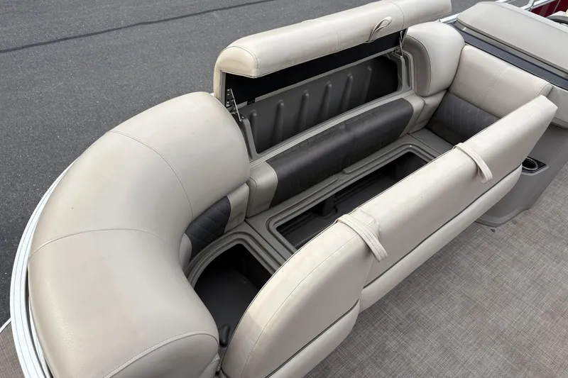 Slide: The Image of 2024 Sun Tracker Party Barge 20 DLX pontoon boat seating with storage compartments open. - 23