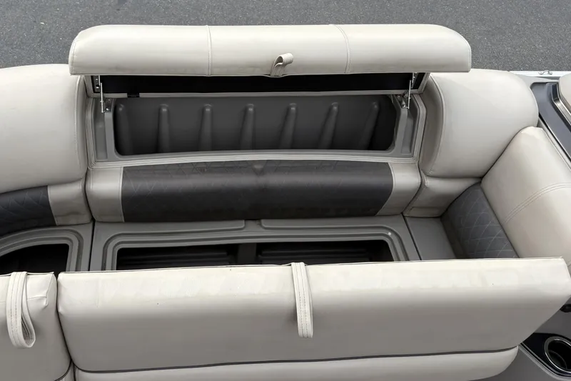 Slide: The Image of 2024 Sun Tracker Party Barge 20 DLX seating with open storage compartment. - 26