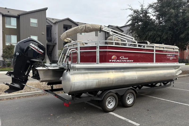 Slide: The Image of 2024 Sun Tracker Party Barge 20 DLX pontoon boat with Mercury engine on trailer. - 3