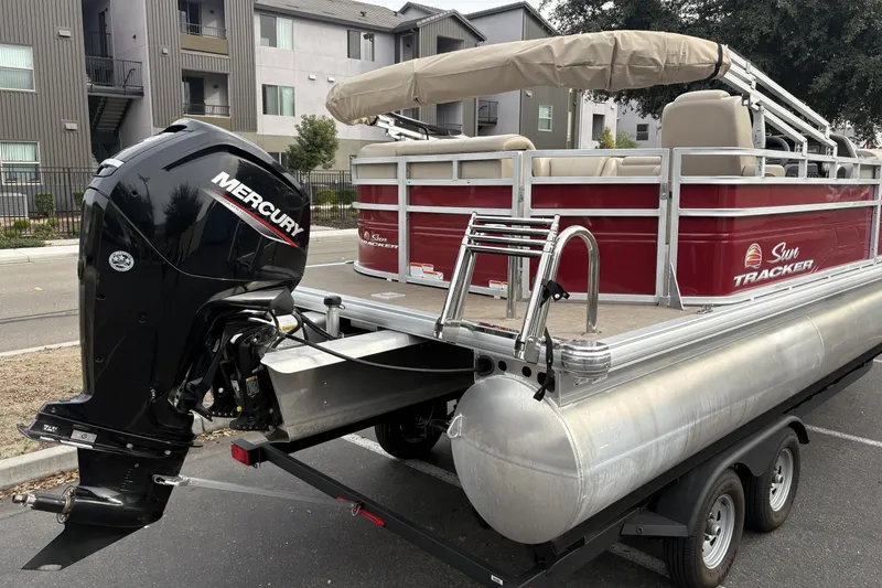 Slide: The Image of 2024 Sun Tracker Party Barge 20 DLX pontoon boat with Mercury engine on trailer. - 5