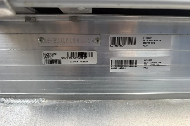 Slide: The Image of 2024 Sun Tracker Party Barge 20 DLX identification labels on aluminum surface. - 86