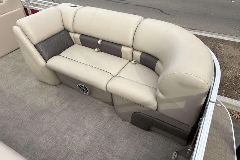 Slide: The Image of 2024 Sun Tracker Party Barge 20 DLX, beige seating, gray flooring, outdoor setting. - 9