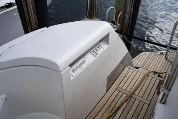 Slide: The Image of 2007 Pershing 62' yacht deck with wooden flooring and water view. - 10