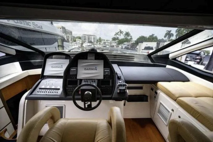 Slide: The Image of Luxurious 2007 Pershing 62' yacht cockpit with Garmin navigation system and plush seating. - 13