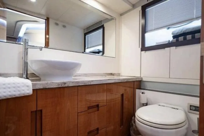 Slide: The Image of Luxurious bathroom interior of 2007 Pershing 62' yacht with modern fixtures and wooden cabinetry. - 2