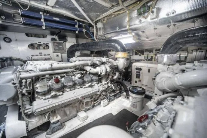 Slide: The Image of Engine room of a 2007 Pershing 62' yacht, showcasing complex machinery and piping. - 4