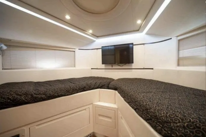 Slide: The Image of Luxurious interior of 2007 Pershing 62' yacht with modern bedding and wall-mounted TV. - 7