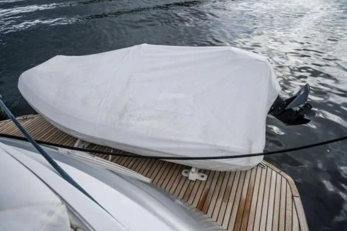 Slide: The Image of Covered boat on a 2007 Pershing 62' yacht's wooden deck by the water. - 8