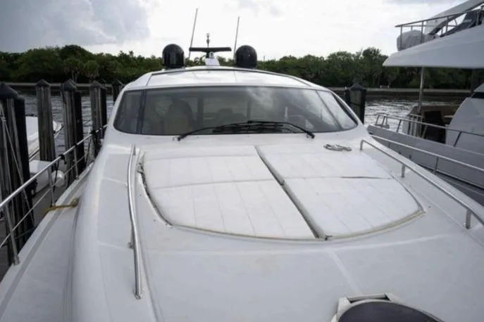 Slide: The Image of 2007 Pershing 62' yacht docked, sleek design, white exterior, luxury vessel. - 9