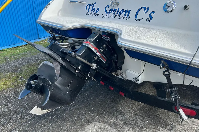 Slide: The Image of 1995 Reinell 18 BRXL boat with MerCruiser engine, named "The Seven C's," on a trailer. - 14