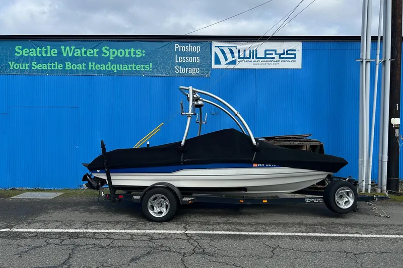 Slide: The Image of 1995 Reinell 18 BRXL boat with cover, parked outside Seattle Water Sports. - 2