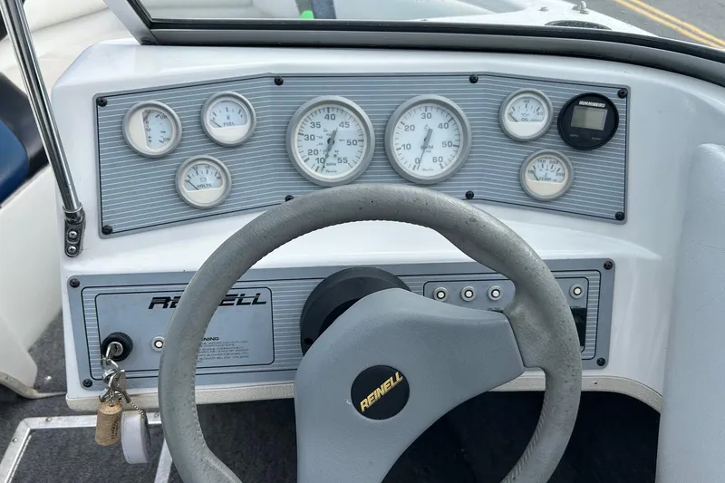 Slide: The Image of Dashboard of a 1995 Reinell 18 BRXL boat with gauges and steering wheel. - 5