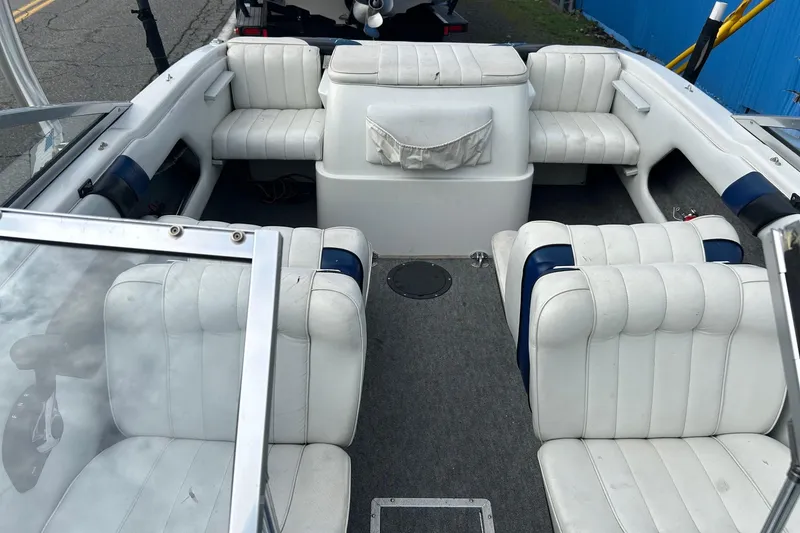 Slide: The Image of 1995 Reinell 18 BRXL boat interior with white seating and carpeted floor. - 9