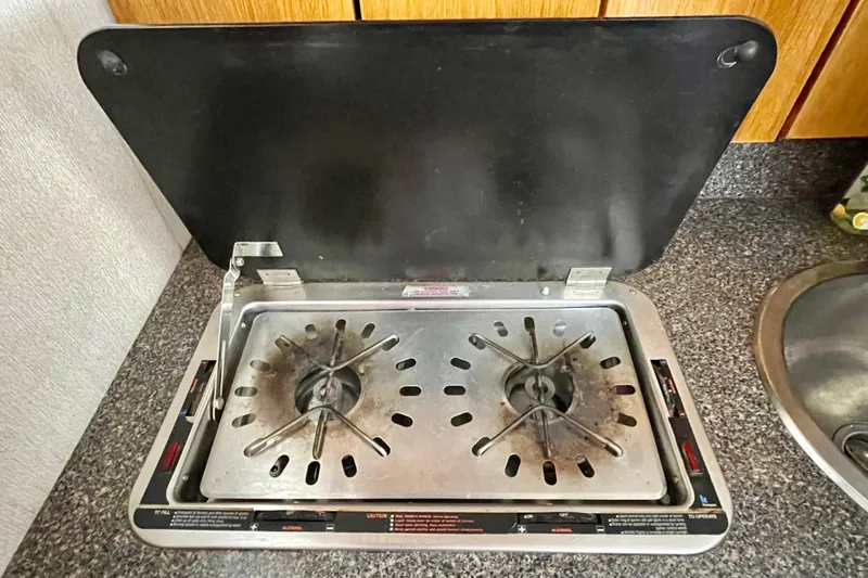 Slide: The Image of Two-burner stove on 1989 Silverton 34 Convertible boat kitchen countertop. - 13