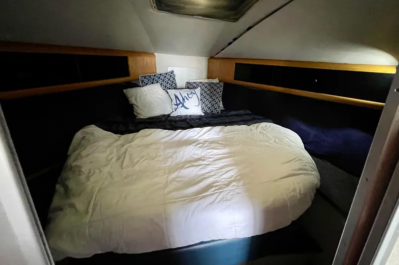 Slide: The Image of Cozy cabin interior of 1989 Silverton 34 Convertible with bed and pillows. - 15