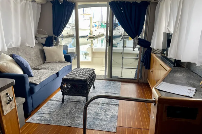 Slide: The Image of Interior of 1989 Silverton 34 Convertible yacht with cozy seating and marina view. - 18