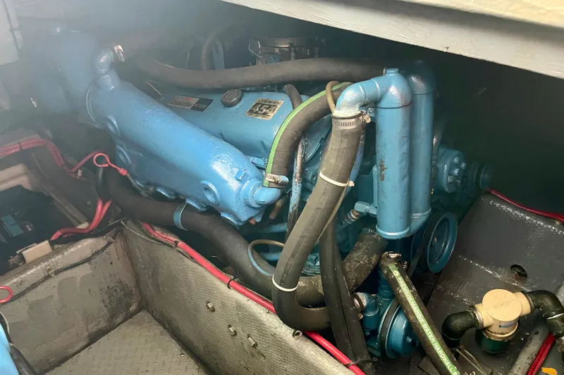 Slide: The Image of Engine compartment of a 1989 Silverton 34 Convertible boat, featuring blue machinery and hoses. - 20