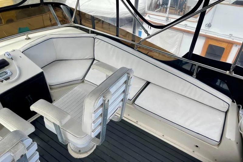 Slide: The Image of 1989 Silverton 34 Convertible boat interior with white seating and helm station. - 5