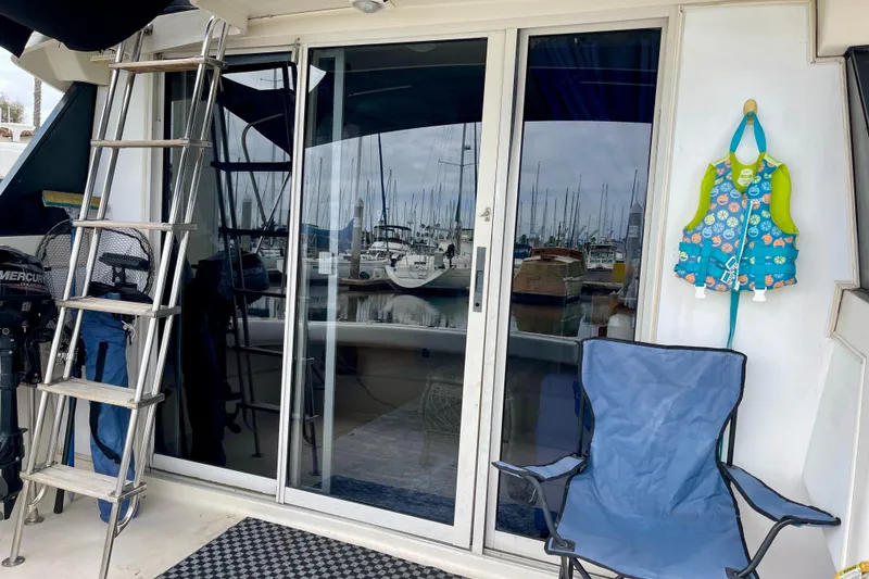 Slide: The Image of 1989 Silverton 34 Convertible boat with ladder, life jacket, and marina view. - 6