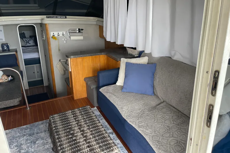 Slide: The Image of Interior of 1989 Silverton 34 Convertible yacht with cozy seating and nautical decor. - 7