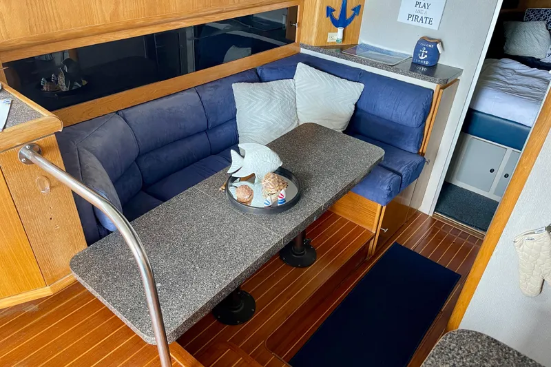 Slide: The Image of Interior of 1989 Silverton 34 Convertible with cozy seating and nautical decor. - 9