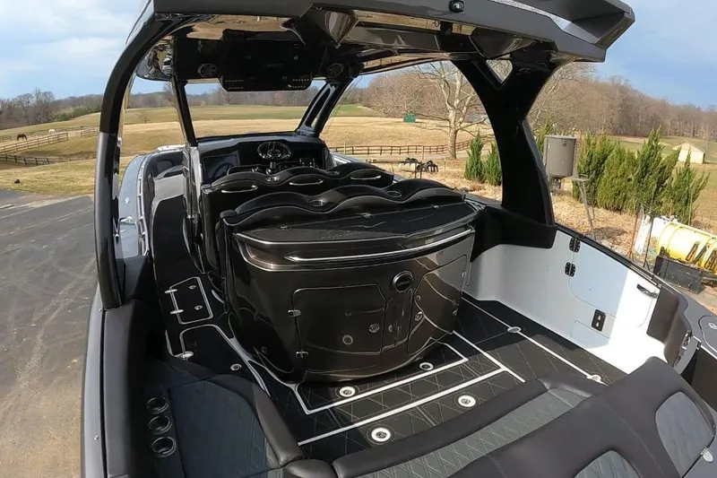 Slide: The Image of 2018 MTI V42 boat interior with sleek design and modern features, set in a rural landscape. - 11