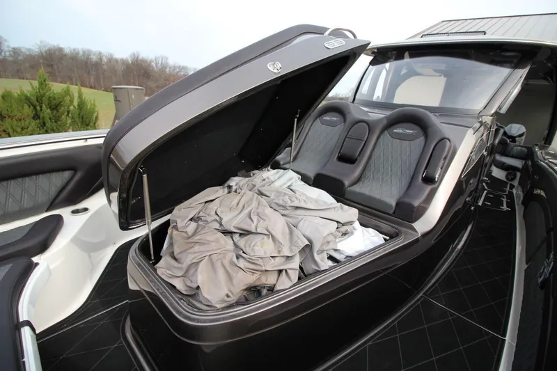 Slide: The Image of Open storage compartment on 2018 MTI V42 boat with seats and fabric inside. - 20