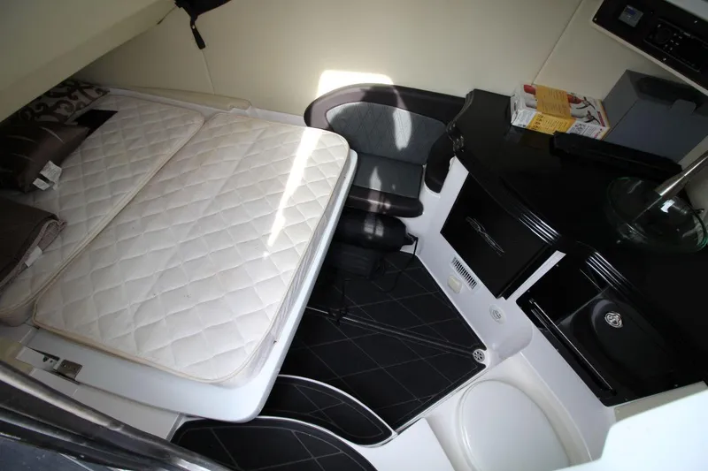 Slide: The Image of 2018 MTI V42 cabin interior with bed, seating, and compact kitchenette. - 23