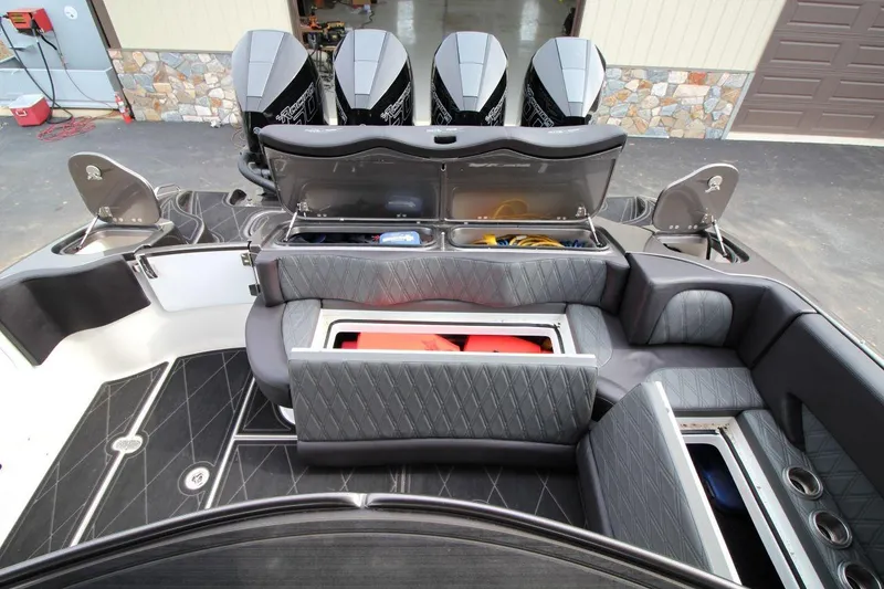 Slide: The Image of 2018 MTI V42 boat interior with storage compartments and multiple outboard engines. - 29
